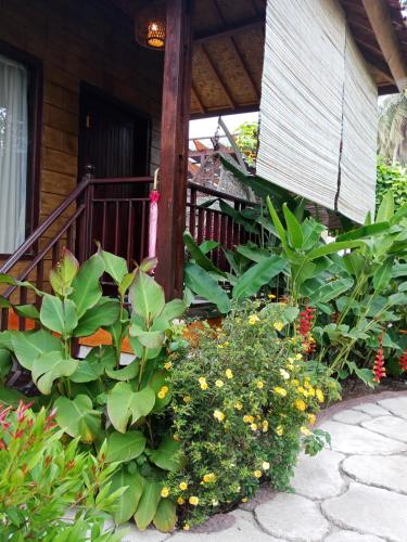a garden of flowers in front of a house at ZiFa Mandalika in Kuta Lombok