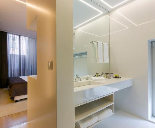 a bathroom with a sink, toilet and shower at Hotel Fabrica do Chocolate in Viana do Castelo