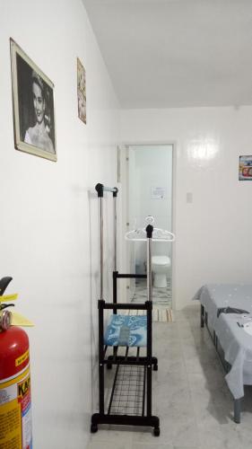 a room with a room with a bed and a shelf at Kathleens Vacation Place in Moalboal