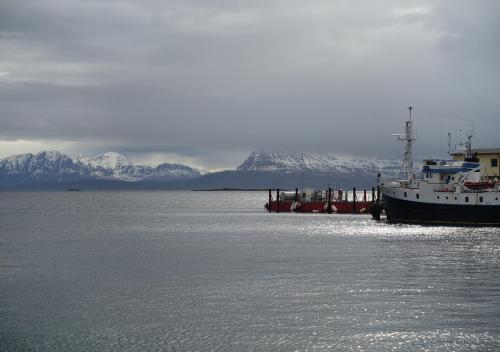 a boat is docked in a body of water at Thon Hotel Harstad in Harstad
