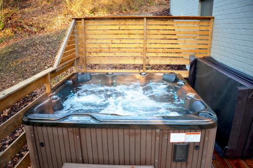 a jacuzzi tub sitting in a backyard at Villa Dakota - jacuzzi, zwembad, playstation in Durbuy