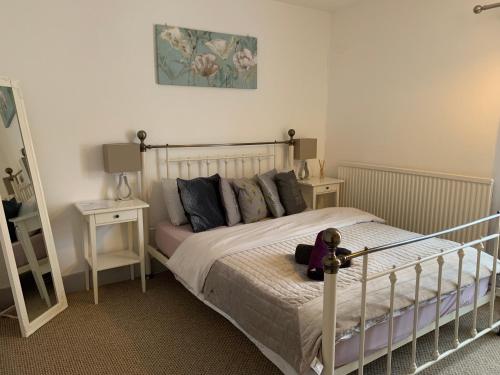 a bedroom with a bed with a teddy bear on it at Fuller Rooms in Kettering