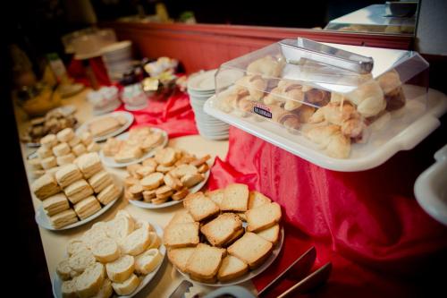 a table filled with different types of bread and pastries at Casablanca Hotel & Spa in Santa Rosa de Calamuchita