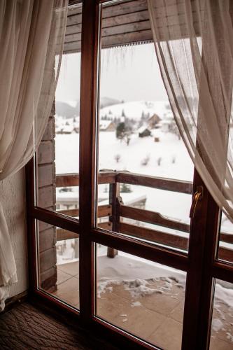 a window with a view of a snow covered yard at SPA HOTEL Gora in Bukovel
