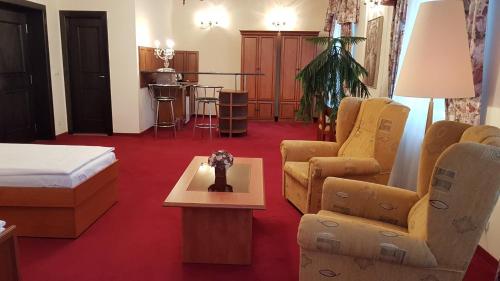 a hotel room with a bed and a table and chairs at Eurohotel in Karlovy Vary