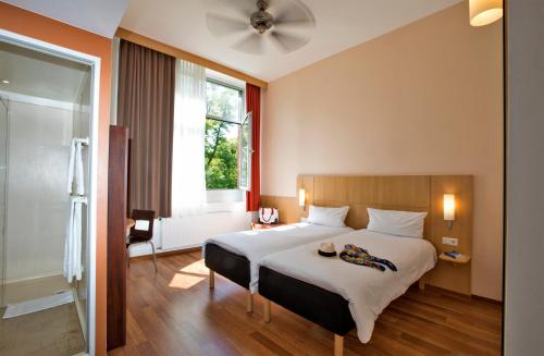 a bedroom with a large bed and a window at ibis Berlin City Süd in Berlin