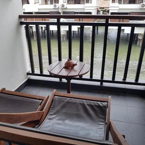 a cat sitting on a table on a balcony at Tokido Private Water Chalet PD in Port Dickson