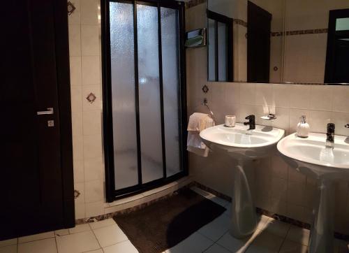a bathroom with two sinks and a large window at Eurohotel in Karlovy Vary