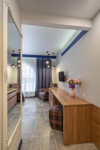 a living room with a desk and a couch at Comfort House in Kyiv
