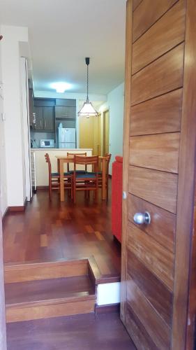 a wooden door leading to a dining room and kitchen at Can Marxant, céntrico, servicios al lado y cruce de senderos in Molló