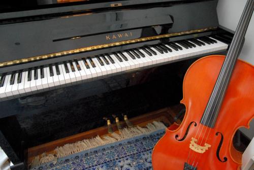 a red guitar sitting next to a piano at Bb Tube in Genova