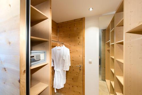 a room with wooden walls and a closet at Naturhotel Leitlhof in San Candido