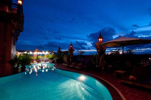 a swimming pool at night with a view at Okay Guesthouse Siem Reap in Siem Reap
