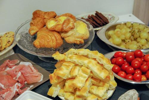 a table topped with plates of pastries and fruit at Bb Tube in Genova
