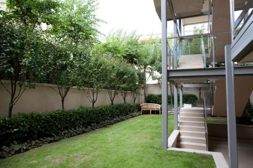 a garden with a stairway leading up to a building at Lakeside Apartments in Wanaka