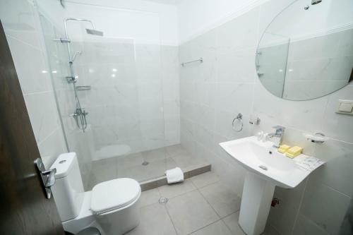 a bathroom with a toilet and a sink and a mirror at Tbilisi View Hotel in Tbilisi City