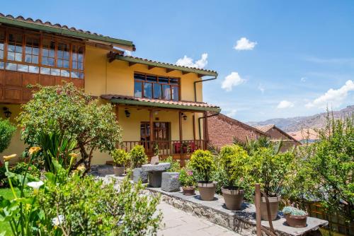 a house with potted plants in front of it at Amaru Inca in Cusco