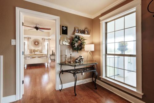 a living room with a table and a window at The Plantation House Boutique Inn in Pflugerville