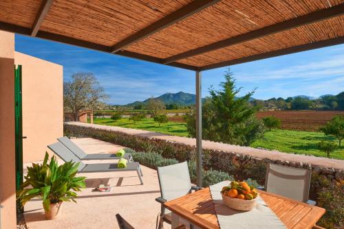a patio with a table and chairs and a view at son capellot in Felanitx