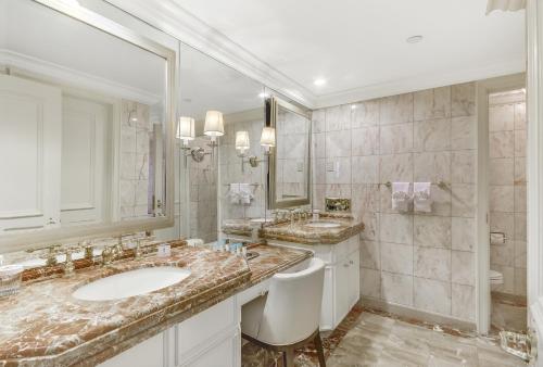 a bathroom with two sinks and a large mirror at Caesars Atlantic City Hotel & Casino in Atlantic City