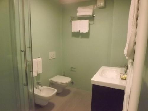 a bathroom with a toilet and a sink at Hotel Bersè in Borgo Val di Taro