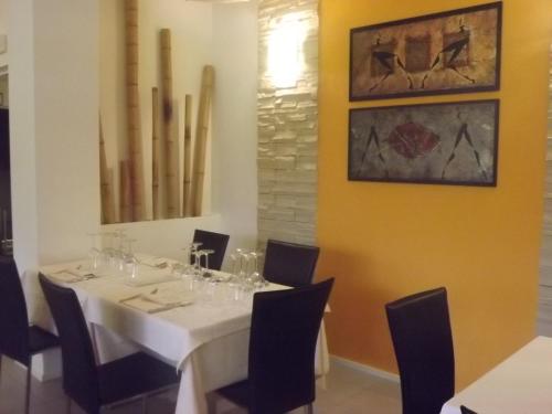 a dining room with a white table and chairs at Hotel Bersè in Borgo Val di Taro