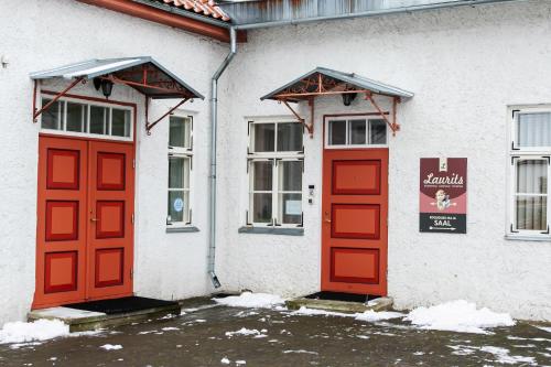 two red doors on the side of a building at Guesthouse Laurits in Kuressaare