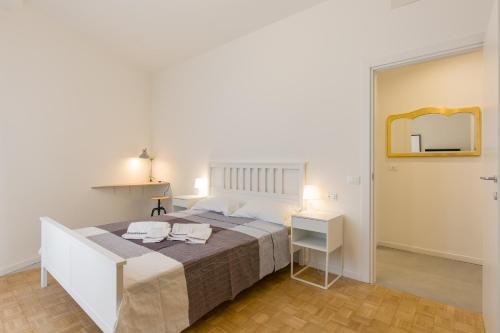 a bedroom with a large bed and a mirror at Residenza Le Mura in Verona