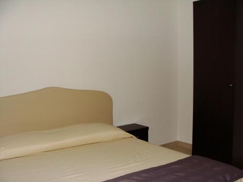a bedroom with a bed and a black cabinet at Hotel Star in Monterotondo