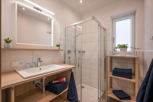 a bathroom with a sink and a shower at Landhaus Desiree in Hopfgarten im Brixental