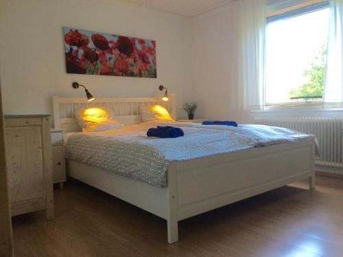 a bedroom with a bed with two blue towels on it at Nyhyttan Nora Bergslagen The Three Birches in Nora