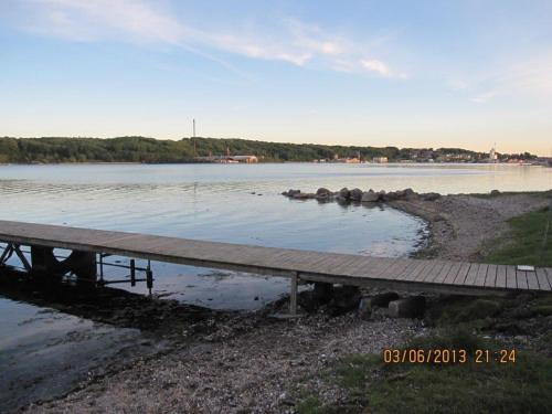 a dock on the shore of a body of water at Hegedal Apartment in Hobro