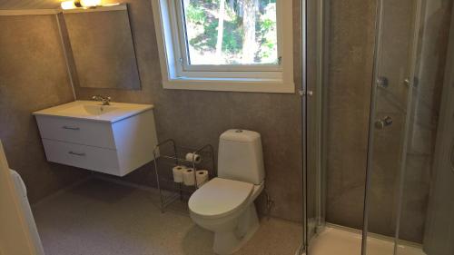 a bathroom with a toilet and a sink and a shower at Eikheim in Birkeland