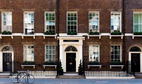 a bike parked in front of a brick building at The Academy - Small Luxury Hotels of the World in London