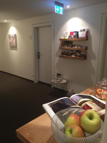 a bowl of apples on a table in a room at Hotel Restaurant Der Engel, Sasbachwalden in Sasbachwalden