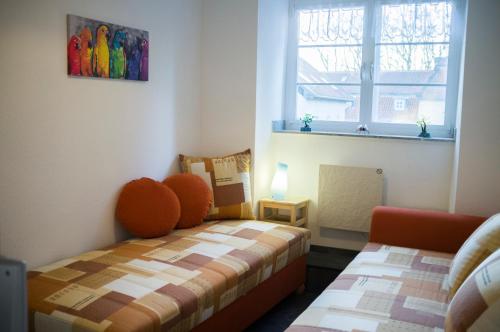 a small bedroom with a bed and a window at Quadenhof in Düsseldorf