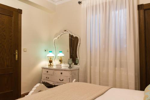 a bedroom with a bed and a mirror on a dresser at Casa Rosalía in Ibi
