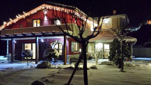 a house with christmas lights on it in the snow at Country House Il Papavero in Bagnoli Irpino
