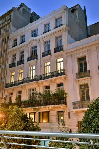 a large white building with windows and balconies at Athenian Vintage Apartments in Athens
