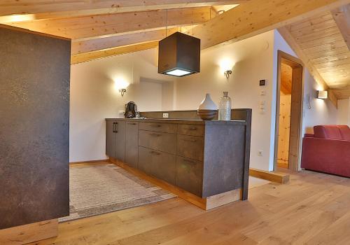 a kitchen with a counter and a couch in a room at Arvenhof in Serfaus