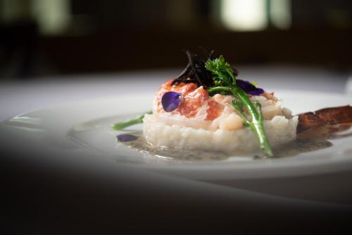 a white plate with a piece of food on a table at Seehotel Restaurant Lackner in Mondsee