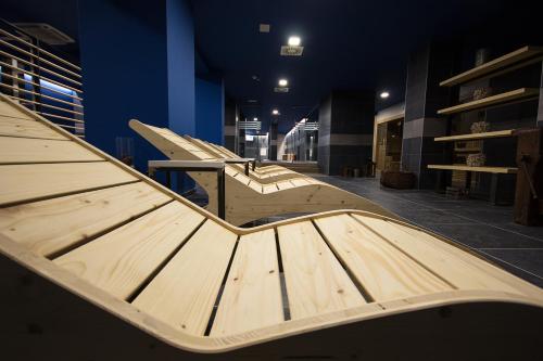 a group of wooden benches in a room at Hotel Europa in Breuil-Cervinia