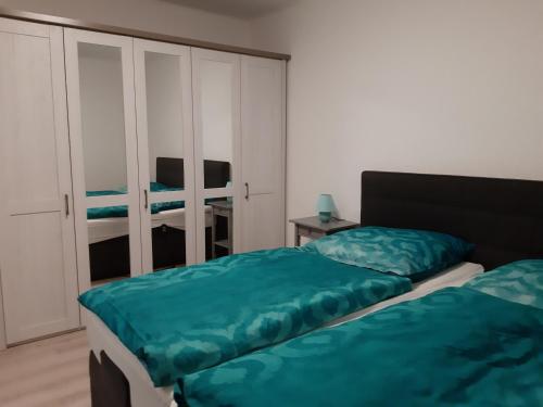 a bedroom with two beds and a closet at Ferienwohnung Elias in Merseburg
