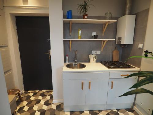 a kitchen with a sink and a counter top at Apartament Mazowiecka 125 in Krakow
