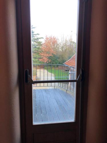 an open door with a view of a balcony at Trommelhoeve Farm Lofts in Boechout