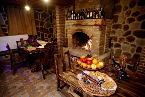 a fireplace in a room with a table with fruits and vegetables at Marani Boutique Hotel in Tbilisi City