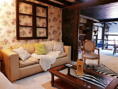 a living room with a couch and a chair at The Patagonian Lodge in Coihaique