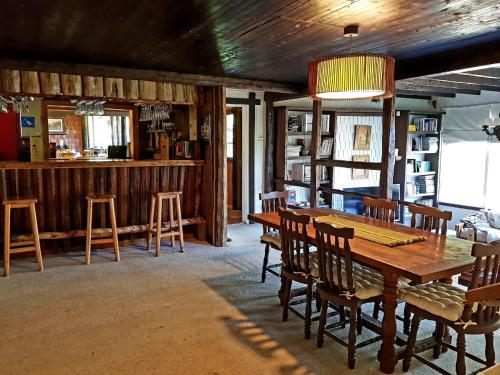 a dining room with a wooden table and chairs at The Patagonian Lodge in Coihaique