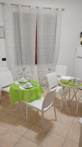a dining room with a table and a table and chairs at B&B Villa dei Sogni in Eboli