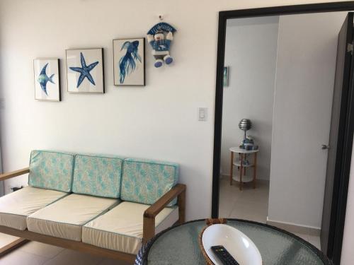 a living room with a couch and a table at Playa La Barqueta , Las Olas Tower Front in David
